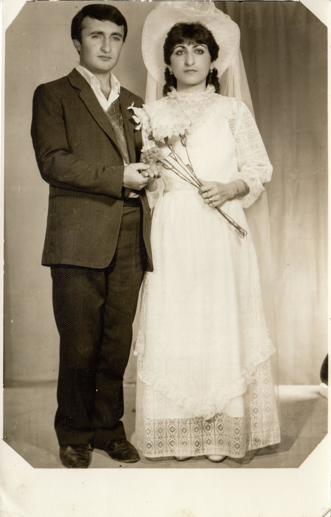 A black and white wedding portrait of a young couple