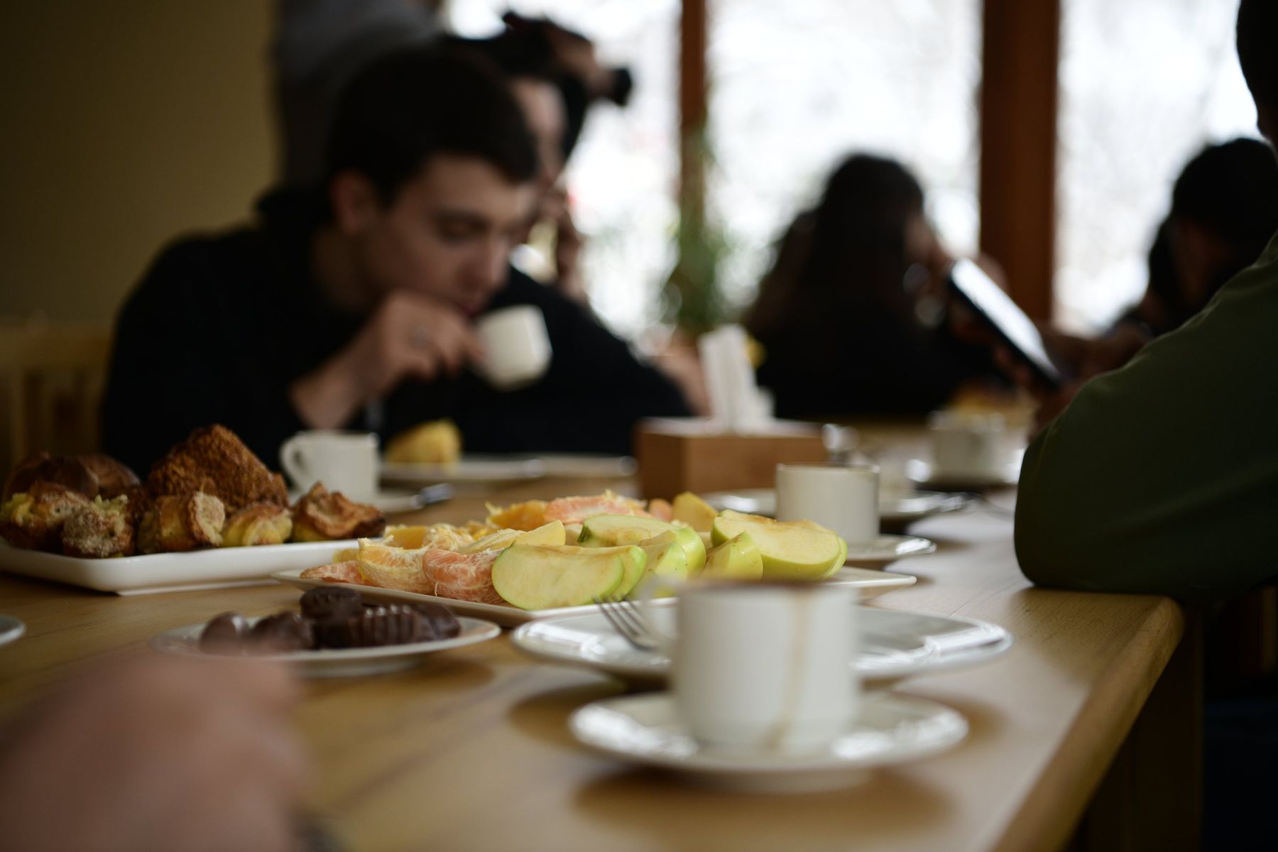 Coffee cups and pastries on a wooden table