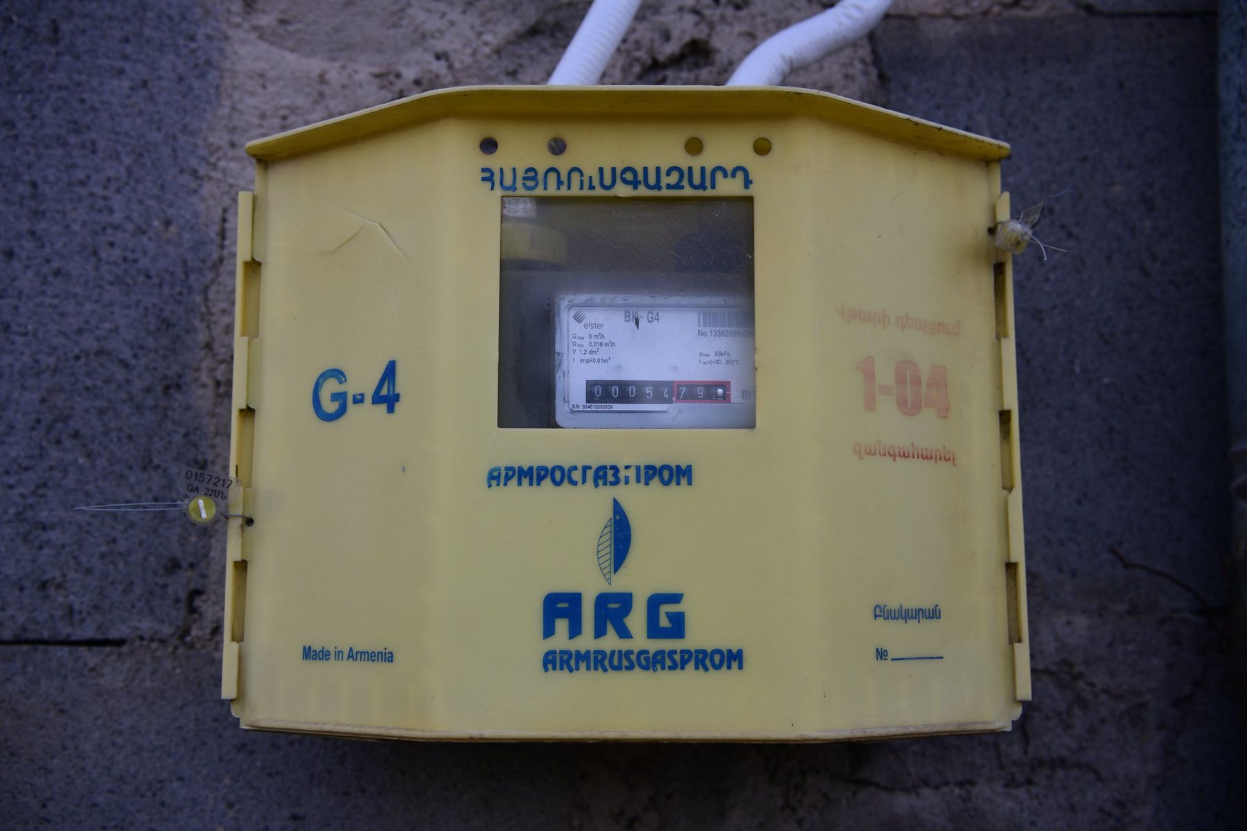 A yellow industrial gas metering box on a wall