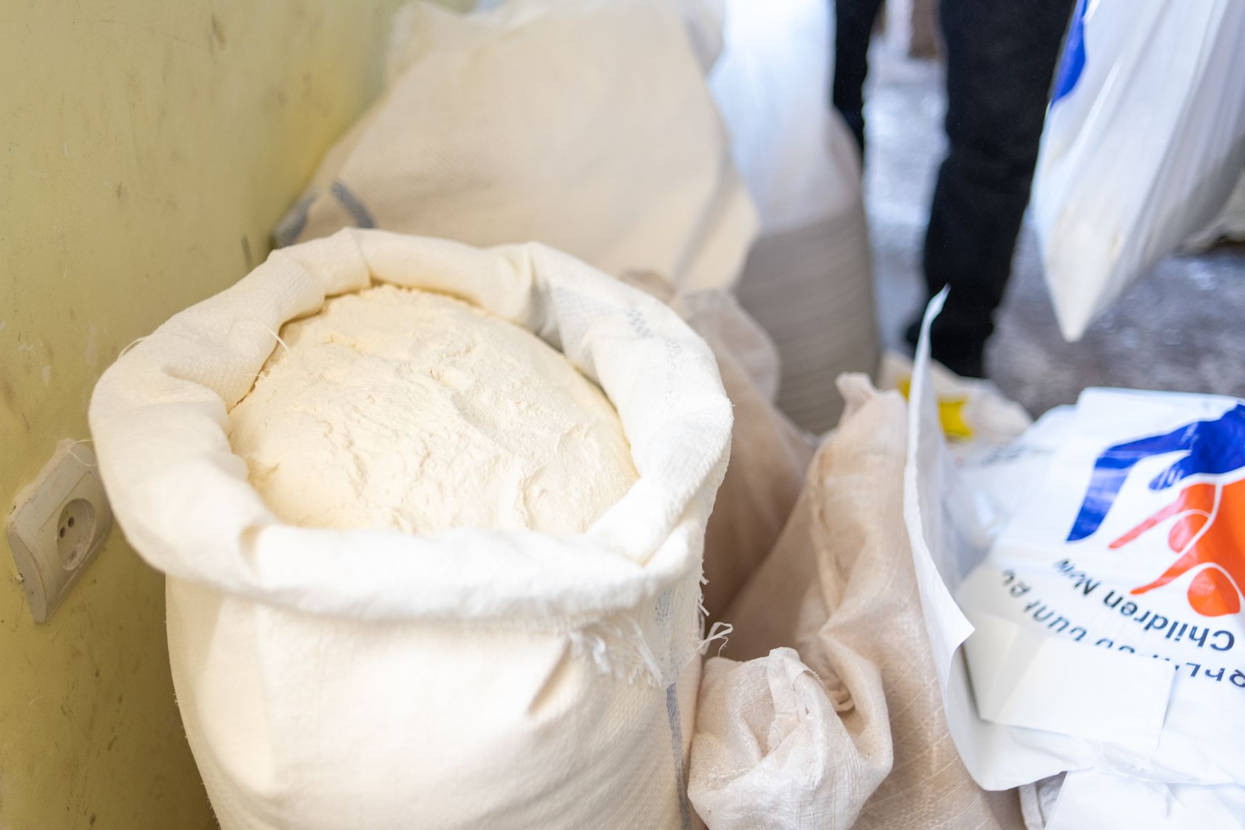 An open sack of flour beside donated bags