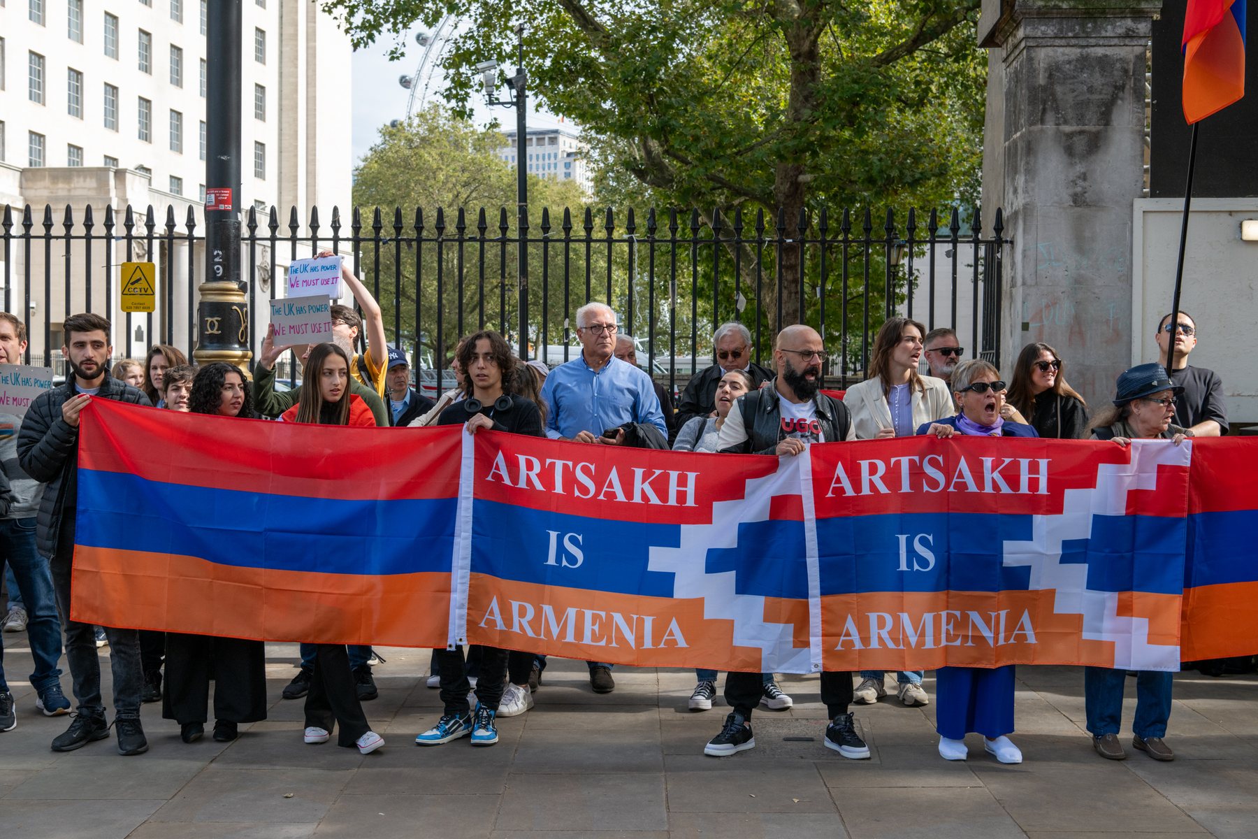A long line of protesters holds Artsakh is Armenia flags