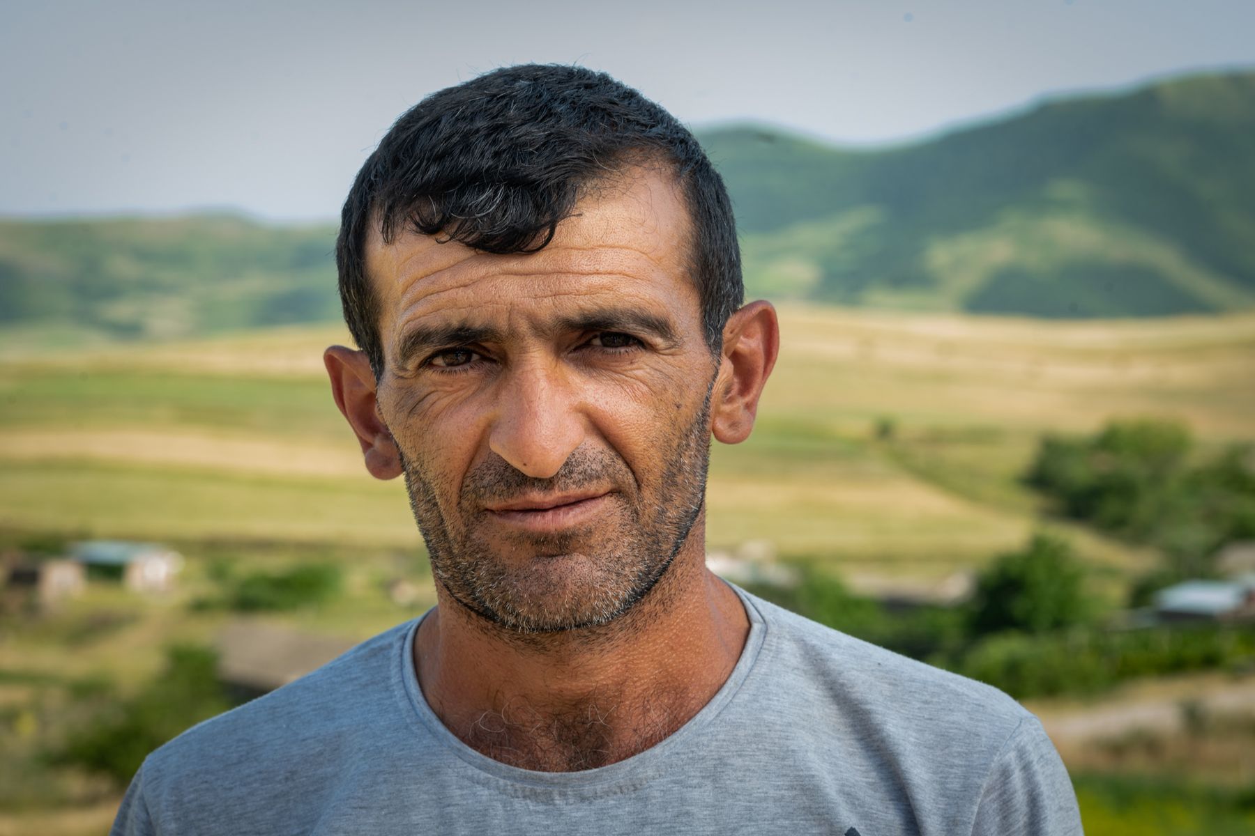 Portrait of a man against a green valley, Tavush